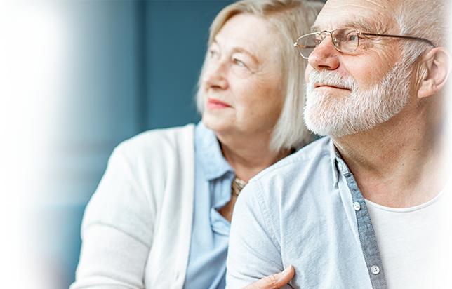 An older couple gazing thoughtfully, symbolizing support and hope in the context of mesothelioma awareness